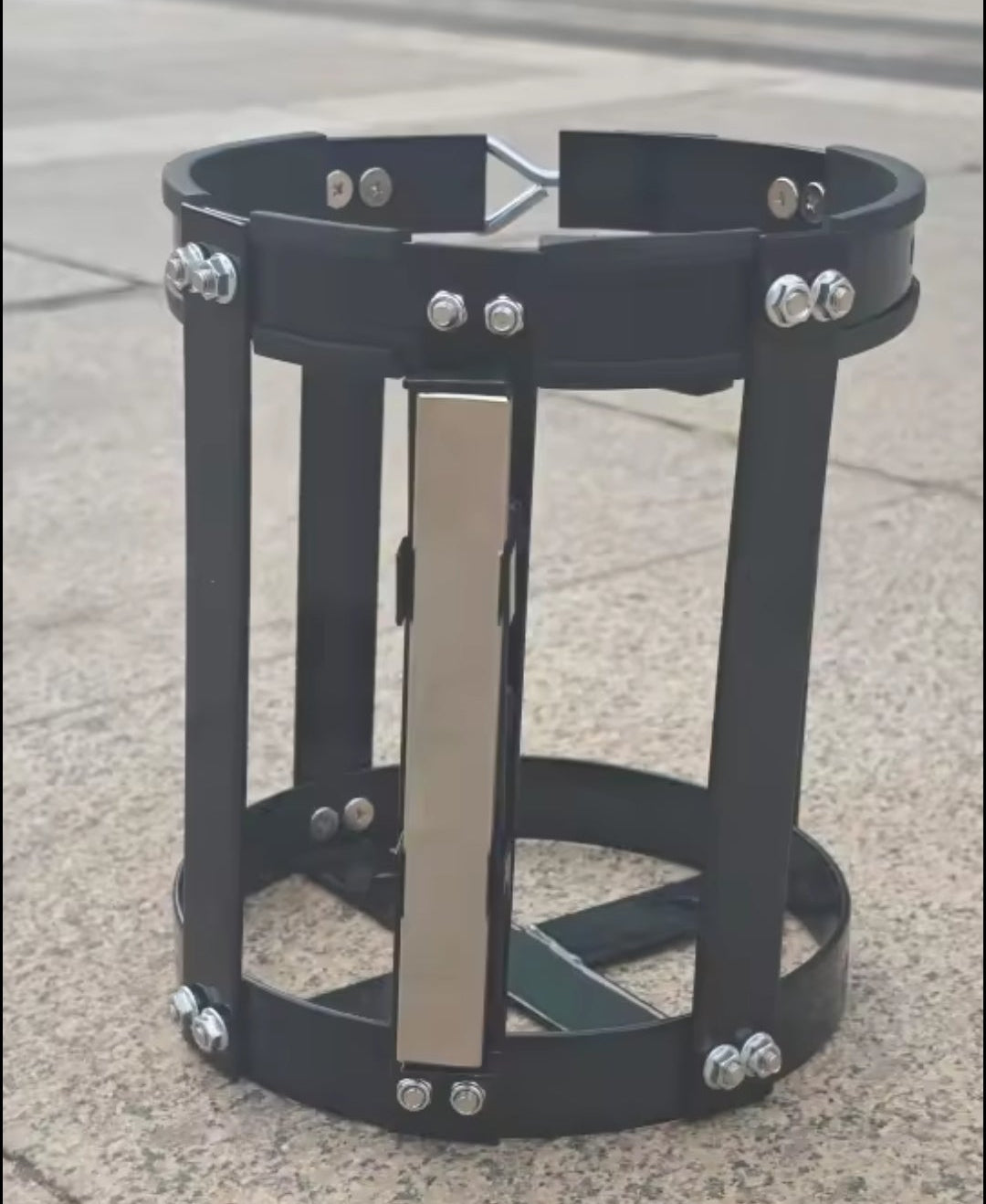 Black metal stand with horizontal bars on a concrete surface