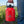 Red Stumptown coffee container held by a person outdoors with greenery and blue sky in the background